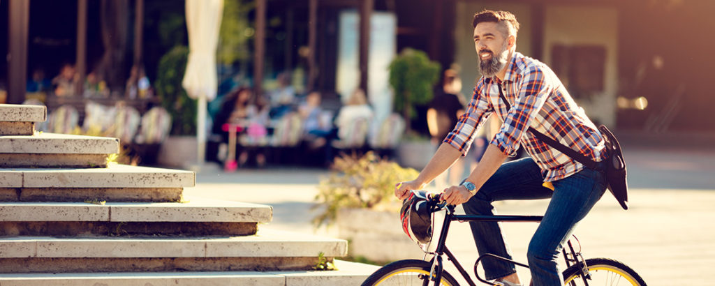 Young man cycling in smart city