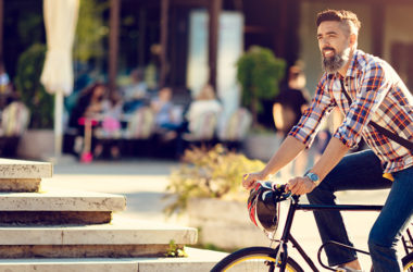 Young man cycling in smart city